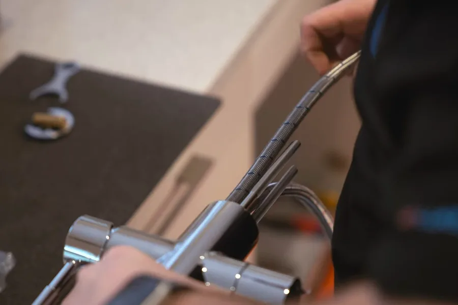 Plumber adjusting a chrome faucet connection for faucet & sink repair in Fountain Hills