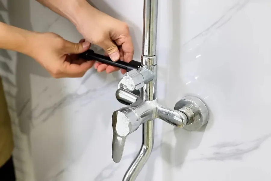 Plumber adjusting a chrome shower valve during a plumbing service call in Desert Canyon, Fountain Hills, AZ