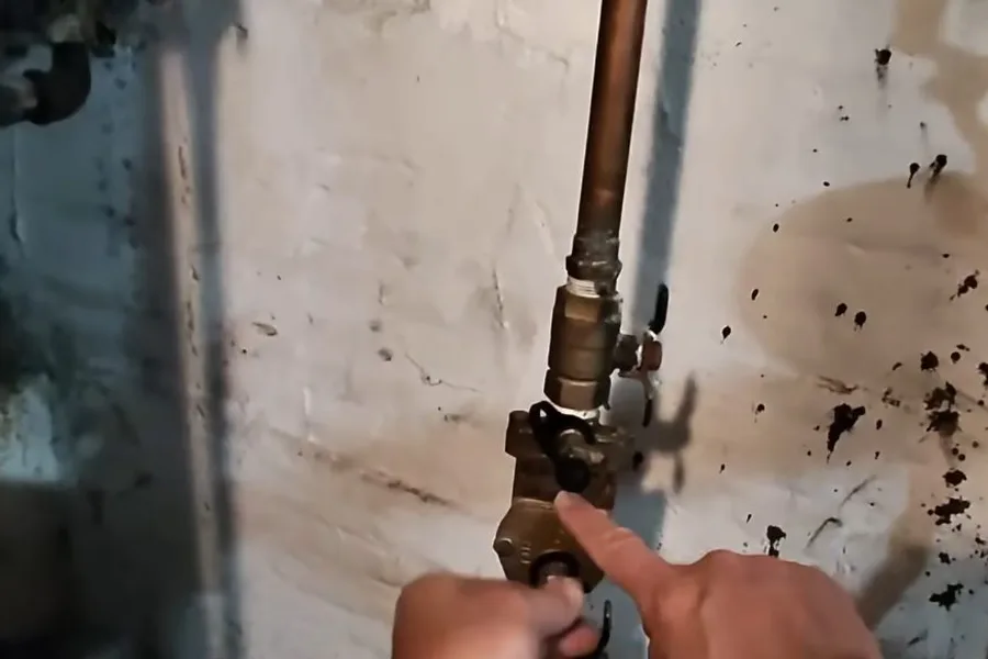 Backflow fitting being tightened at a wall for backflow testing & prevention in Fountain Hills