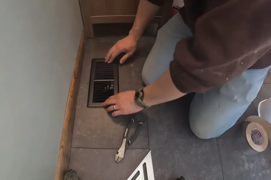 Bathroom floor drain opening with tools nearby during a plumbing service call in North Fountain Hills, AZ