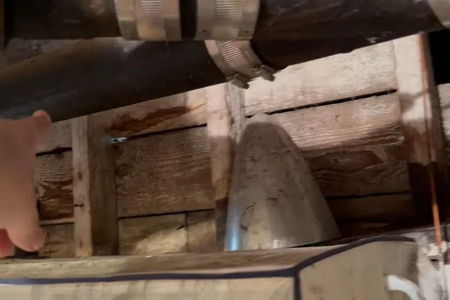 Black drain pipe running under wood framing during a plumbing service call in Adero Canyon, Fountain Hills, AZ