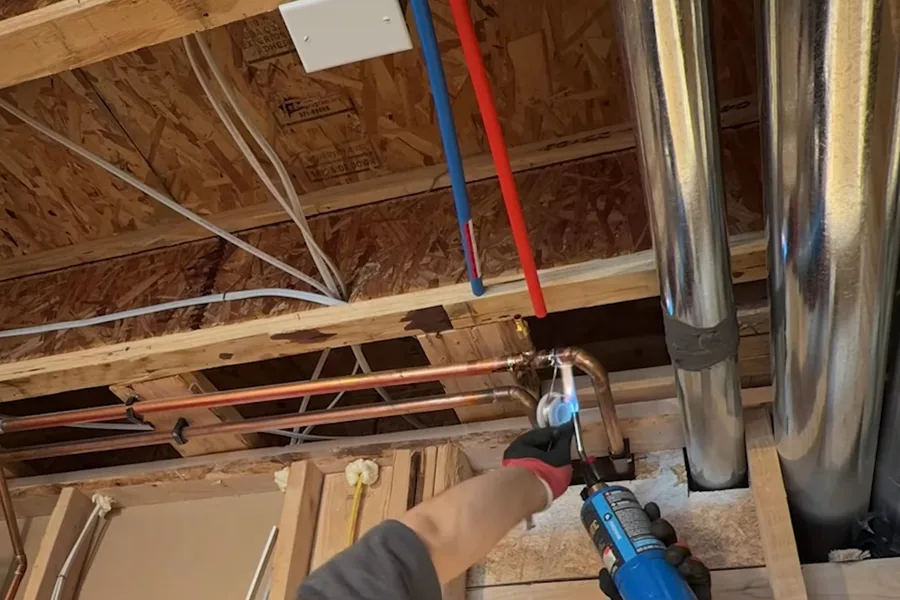 Blue and red pex rough-in above ceiling framing during a plumbing service call in Paradise Valley, AZ