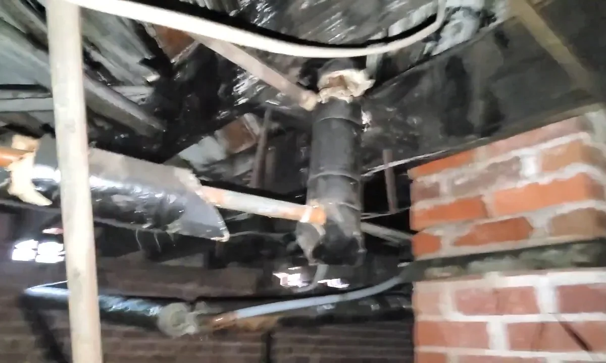 Crawl space drain piping with leak staining during a plumbing service call in Phoenix, AZ