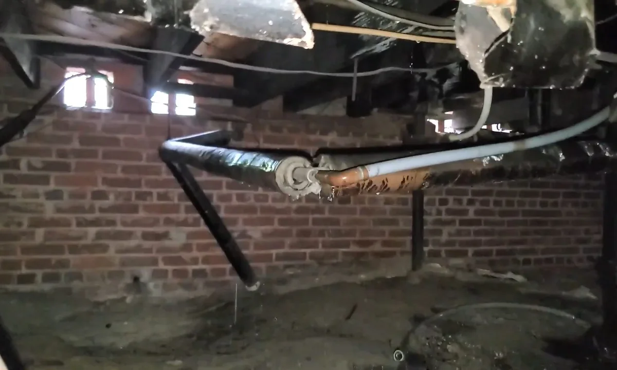 Crawl space puddle below drain piping showing the Fountain Hills AZ Plumbing Experts service approach