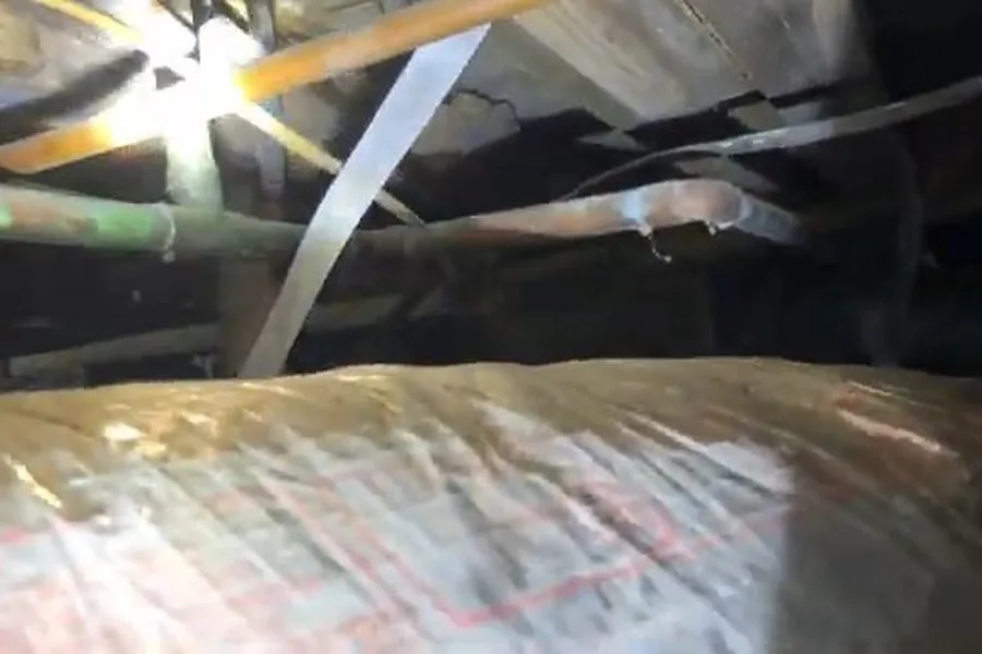 Crawlspace plumbing under floor joists during a plumbing service call in Tempe, AZ