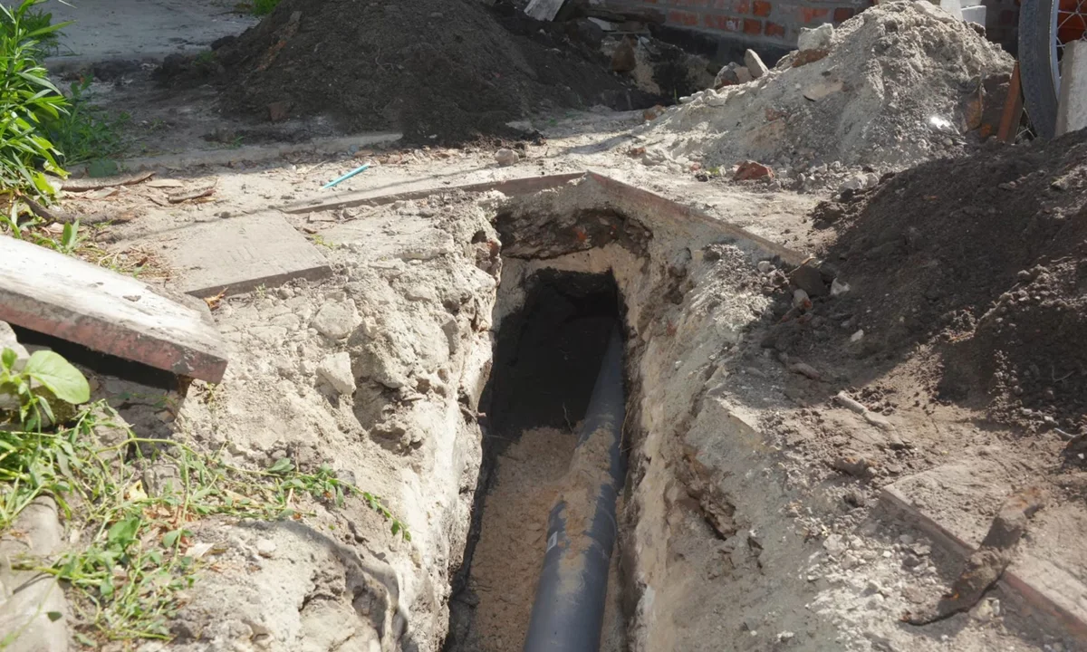 Deep sewer trench exposing pipe bedding illustrating sewer line repair in fountain hills