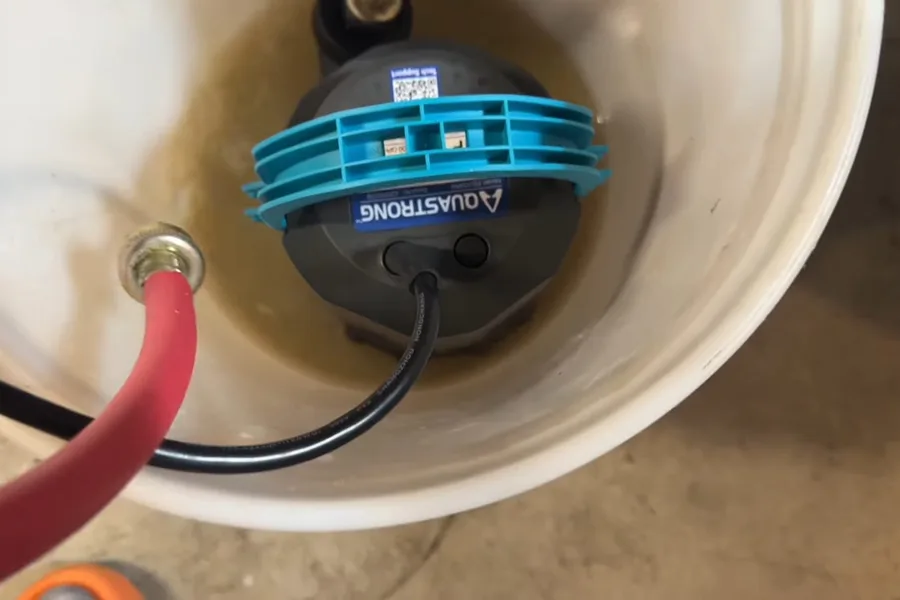 Flush pump and hose inside a bucket for tankless water heater services in Fountain Hills
