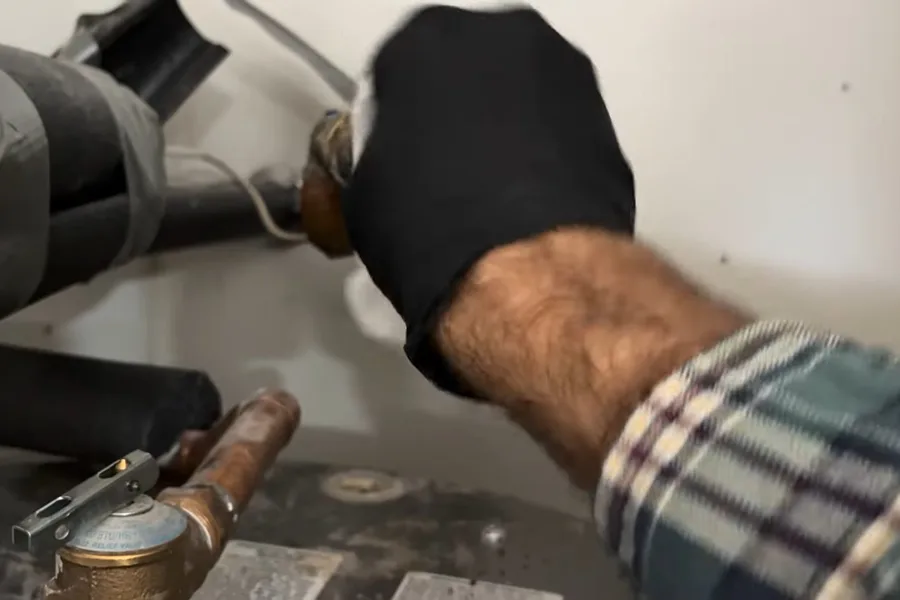 Hand replacing a water heater inlet hose connection for hose bib & outdoor faucet repair in Fountain Hills