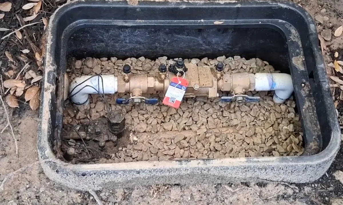 Irrigation backflow box set in gravel for backflow testing & prevention in Fountain Hills
