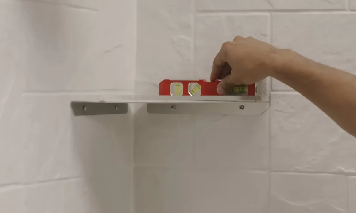 Level held against new shower tile for shower & bathtub installation in Fountain Hills