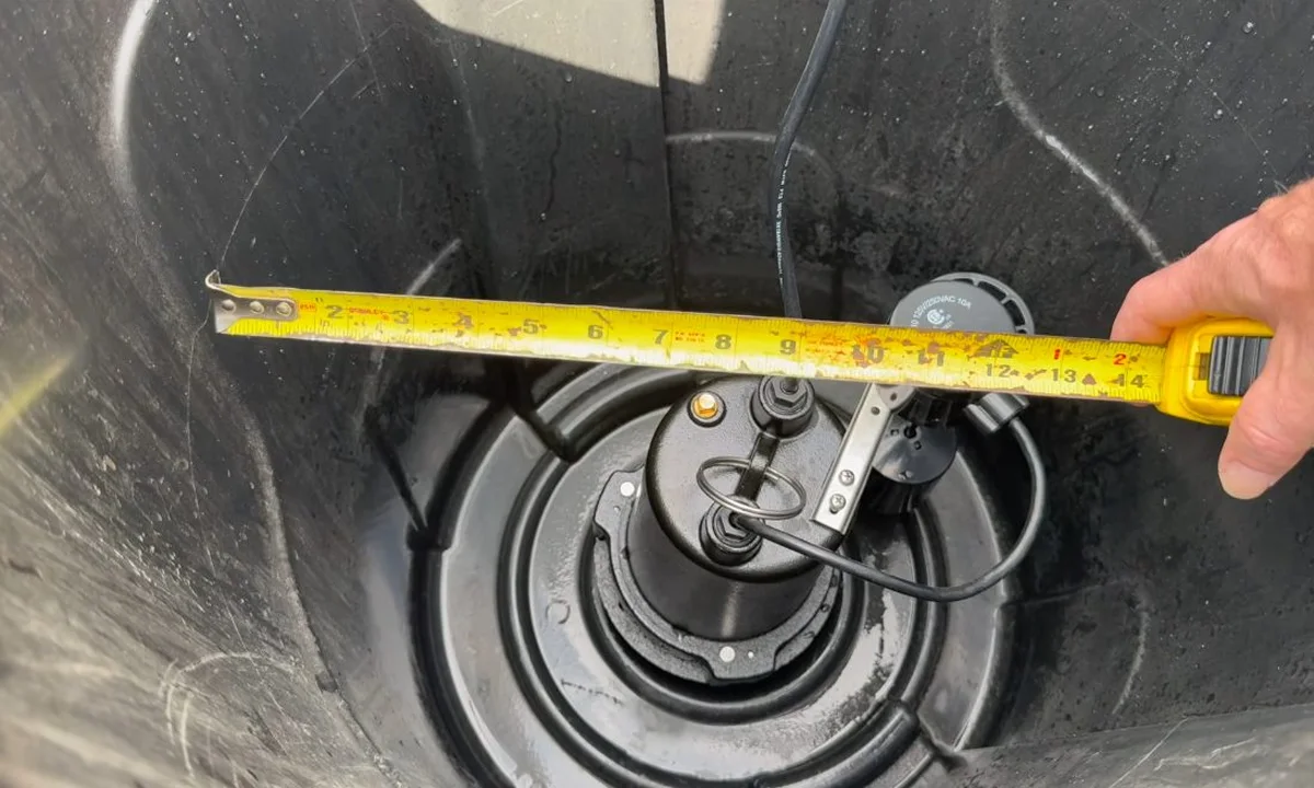 Measuring tape across a sump pump pit lid illustrating is my fountain hills pool leaking or just evaporating? the bucket test and beyond