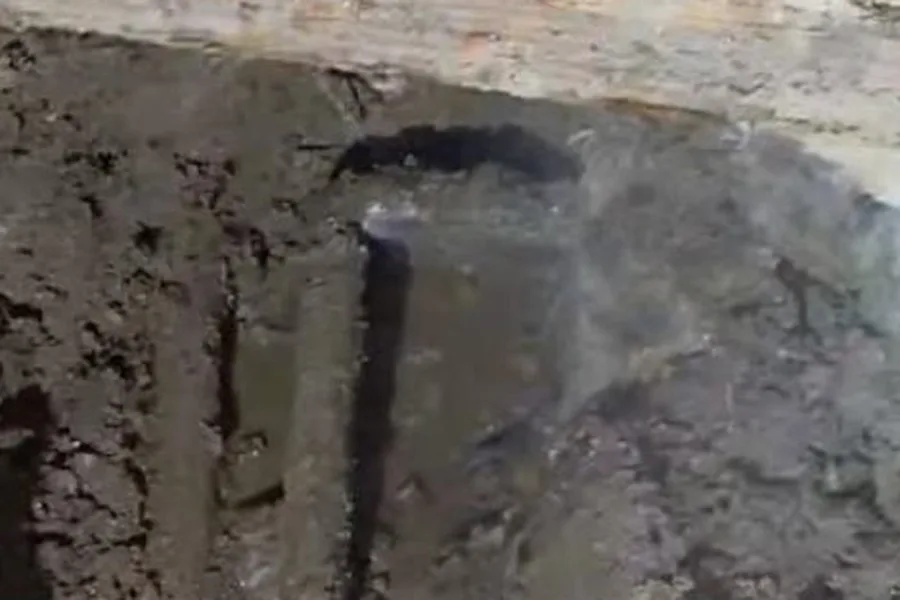 Narrow slab trench exposing soil below concrete for slab leak detection & repair in Fountain Hills