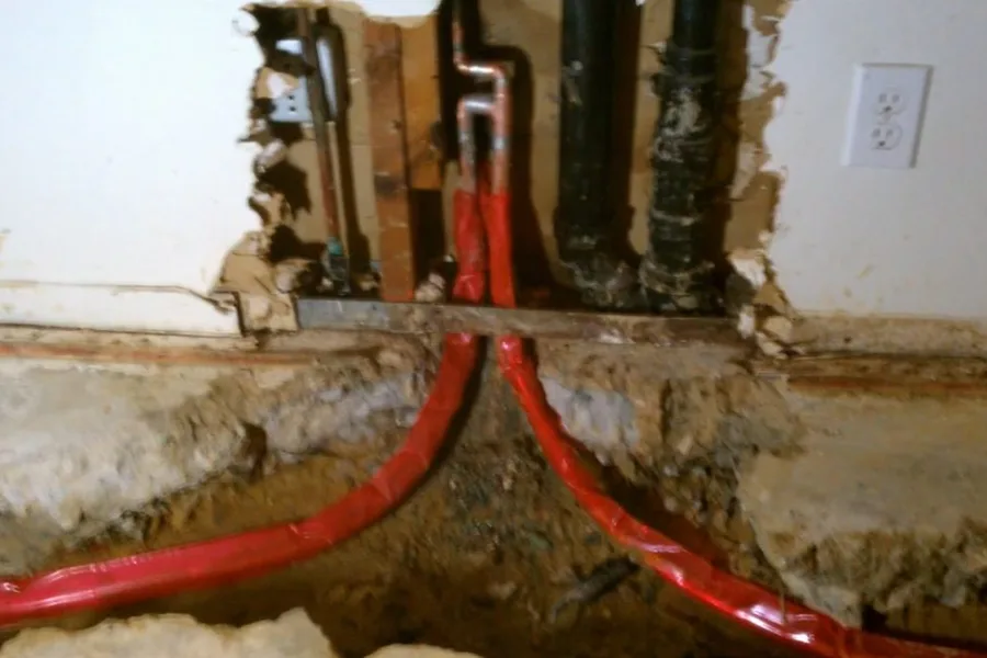 Pex lines exposed below a wall opening for repiping & whole-home pipe replacement in Fountain Hills