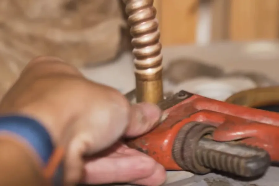 Red pipe wrench tightening a drain line for drain cleaning & unclogging in Fountain Hills