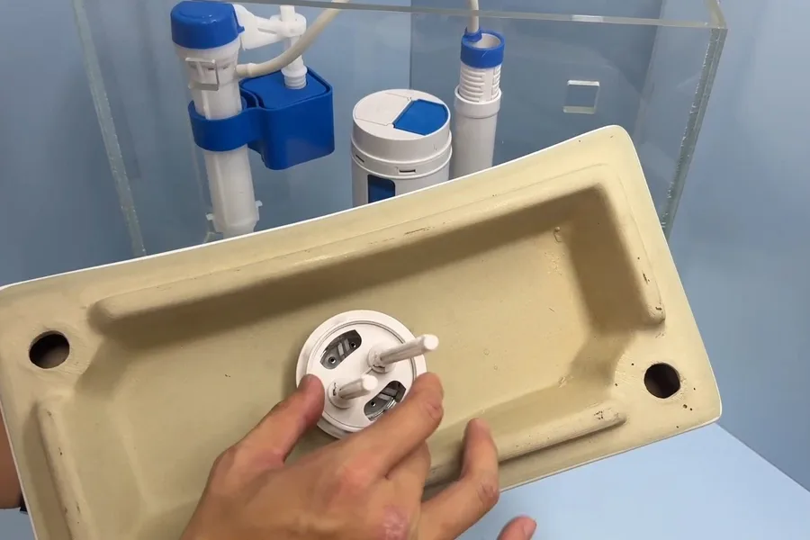 Toilet tank fill valve held above a tank for toilet repair & installation in Fountain Hills