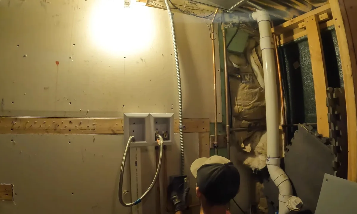 Washer supply and drain lines in an open wall during a plumbing service call in Downtown Fountain Hills, AZ