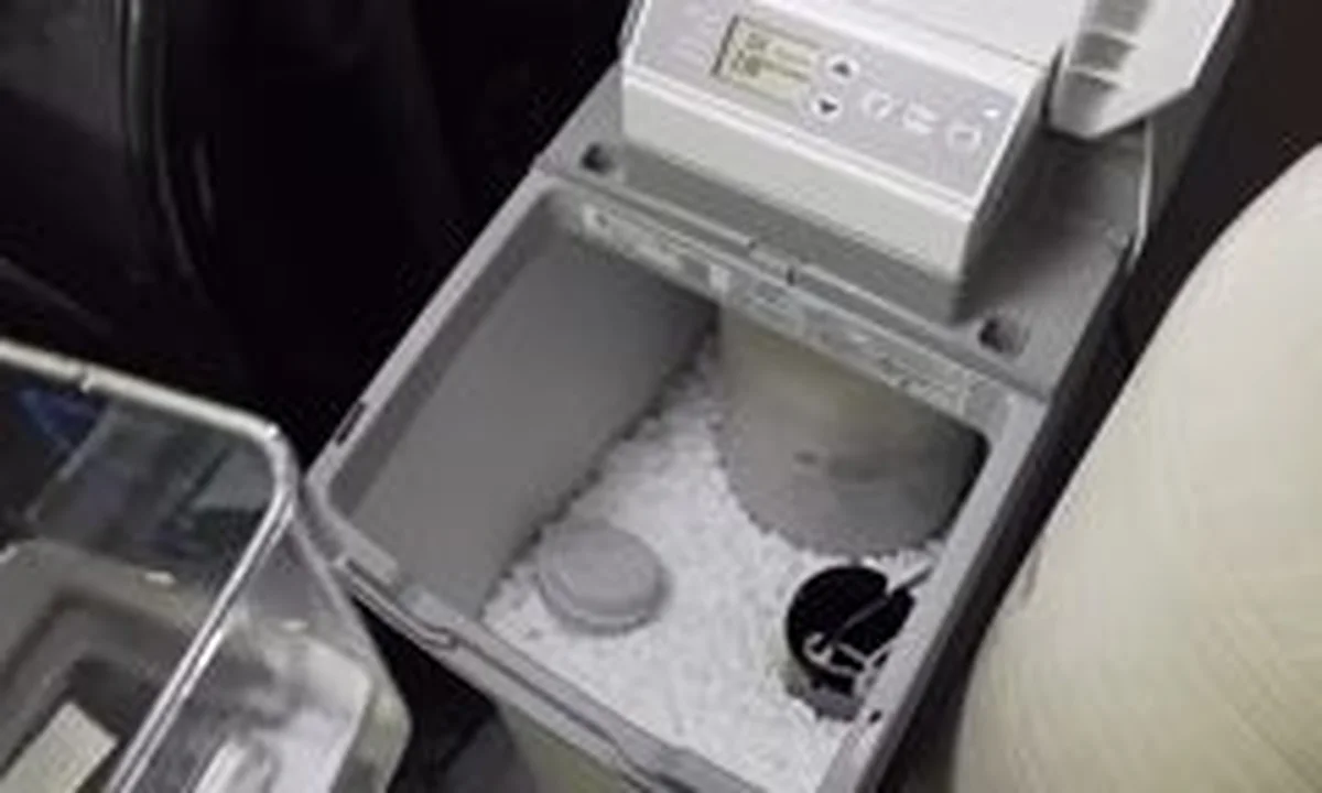 Water softener brine tank filled with salt illustrating softener vs. reverse osmosis vs. whole-house filtration