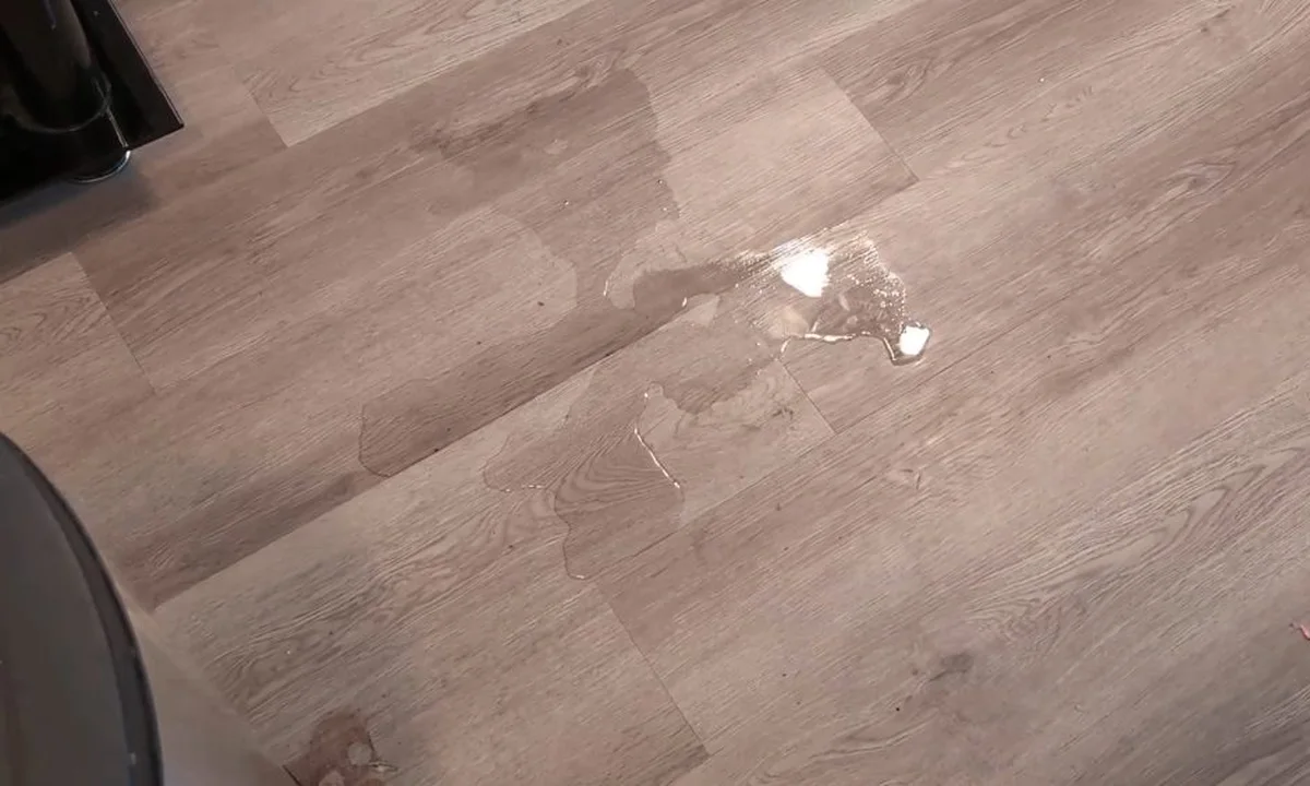 Water spot on flooring from a hidden leak illustrating the warning signs of a slab leak every fountain hills homeowner should know