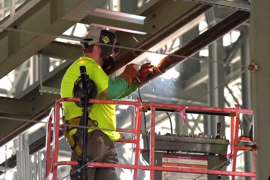 Worker on a lift installing commercial plumbing for commercial plumbing in Fountain Hills