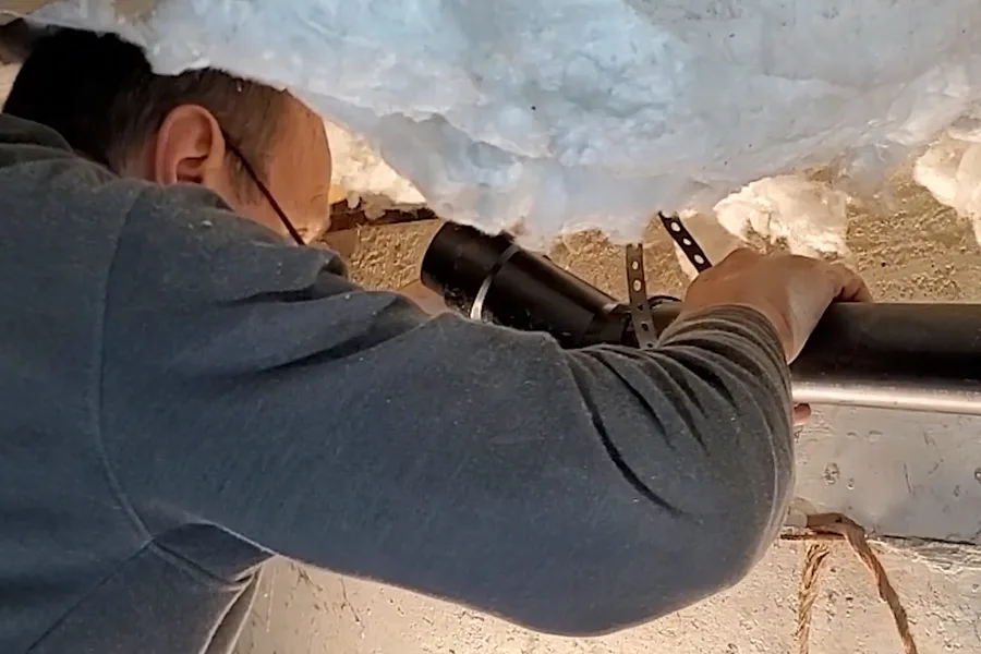 Plumber working inside a crawl space during a plumbing service call in Shea Boulevard Corridor, Fountain Hills, AZ